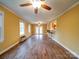 Spacious living room featuring wood floors, two ceiling fans, and natural light from multiple windows at 211 9Th St, Belmont, NC 28012