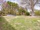 Expansive backyard with a pool and a boat, surrounded by mature trees and lush greenery at 2200 Peninsula Ave, Shelby, NC 28150