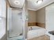 An en suite bathroom featuring a shower, a soaking tub, and tiled walls at 2200 Peninsula Ave, Shelby, NC 28150