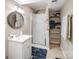 Updated bathroom featuring a shower, vanity, round mirror, and convenient shelving for storage at 2200 Peninsula Ave, Shelby, NC 28150