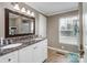 Well-lit bathroom featuring double sinks, granite countertops, and tile flooring at 2200 Peninsula Ave, Shelby, NC 28150