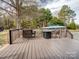 Inviting outdoor deck featuring patio furniture, fire pit, and boat in the background at 2200 Peninsula Ave, Shelby, NC 28150