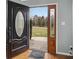 Open front door with decorative glass and welcome mat, revealing a bright, landscaped yard at 2200 Peninsula Ave, Shelby, NC 28150