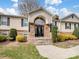 Charming home featuring a stone-accented entry, a black front door, and neatly manicured landscaping at 2200 Peninsula Ave, Shelby, NC 28150