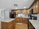 Classic kitchen features wooden cabinets, an island with countertop, and modern appliances at 2200 Peninsula Ave, Shelby, NC 28150