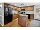 Well-lit kitchen features granite countertops, modern appliances, and wood cabinetry at 2200 Peninsula Ave, Shelby, NC 28150