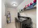 Functional laundry room with modern washer, dryer, water heater, and ample storage shelving at 2200 Peninsula Ave, Shelby, NC 28150