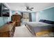 A bright main bedroom with a window, ceiling fan, and modern furnishings at 2200 Peninsula Ave, Shelby, NC 28150