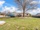 Spacious yard with mature trees and a boat, blending nature with convenience at 2200 Peninsula Ave, Shelby, NC 28150