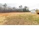 Large backyard featuring a wooden shed and mature trees in a serene setting at 288 John L Hudson Sr Rd, Lancaster, SC 29720