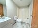 This bathroom offers a combination tub and shower, single sink, and vinyl flooring at 288 John L Hudson Sr Rd, Lancaster, SC 29720