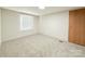 Simple bedroom featuring neutral carpet, a window, and a closet door at 288 John L Hudson Sr Rd, Lancaster, SC 29720