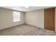 An empty bedroom featuring neutral walls, plush carpeting, and bright natural light at 288 John L Hudson Sr Rd, Lancaster, SC 29720