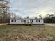 A front view of the home, which features a small deck and vinyl siding at 288 John L Hudson Sr Rd, Lancaster, SC 29720