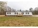 Single-story home with a wooden porch, black shutters, and a well-maintained lawn at 288 John L Hudson Sr Rd, Lancaster, SC 29720