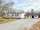 Front exterior view of the home with a detached shed and long gravel driveway at 288 John L Hudson Sr Rd, Lancaster, SC 29720