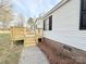 The exterior of the home includes a nice-sized wooden deck and white vinyl siding with black shutters at 288 John L Hudson Sr Rd, Lancaster, SC 29720