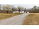 The house has a front deck and a gravel driveway, with an outbuilding off to the side at 288 John L Hudson Sr Rd, Lancaster, SC 29720