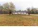 Charming home featuring a gravel driveway and blossoming trees at 288 John L Hudson Sr Rd, Lancaster, SC 29720