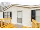 Close-up of the front entrance with a wooden porch, black shutters, and white siding at 288 John L Hudson Sr Rd, Lancaster, SC 29720