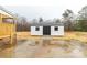 Exterior view of a white storage shed with black doors and trim, enhancing the property's utility at 288 John L Hudson Sr Rd, Lancaster, SC 29720