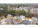 Community aerial showcasing homes surrounded by mature trees in a cul-de-sac at 303 Cupped Oak Ct, Charlotte, NC 28213