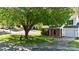 Charming two-story home with lush green lawn and mature tree providing shade at 303 Cupped Oak Ct, Charlotte, NC 28213