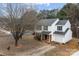 Inviting two-story home featuring a classic facade, attached garage and spacious driveway at 303 Cupped Oak Ct, Charlotte, NC 28213