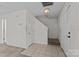 Bright foyer with tile flooring, staircase and neutral paint, leading to other rooms at 303 Cupped Oak Ct, Charlotte, NC 28213