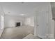 Neutral living room with fireplace, carpet, and large window at 303 Cupped Oak Ct, Charlotte, NC 28213