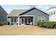 Cozy backyard showcasing the back porch with outdoor furniture and exterior of the home at 305 Kentmere Ln, Clover, SC 29710