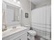 Well-lit bathroom features a vanity, a large mirror, and a shower with neutral color palette at 305 Kentmere Ln, Clover, SC 29710