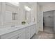 Bright bathroom showcasing double sinks with white cabinets, mirrors, and updated fixtures at 305 Kentmere Ln, Clover, SC 29710