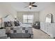 Cozy bedroom features a ceiling fan, dresser, chair, and bright window for natural light at 305 Kentmere Ln, Clover, SC 29710