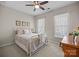 Charming bedroom with a white metal frame bed, vintage dresser, and sun-drenched windows at 305 Kentmere Ln, Clover, SC 29710