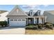 Charming one-story home with a well-manicured lawn and inviting front porch at 305 Kentmere Ln, Clover, SC 29710