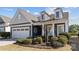 Well-maintained home exterior featuring an attached two-car garage and manicured landscaping at 305 Kentmere Ln, Clover, SC 29710
