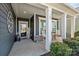 Inviting front porch with rocking chairs, decorative accents, and classic columns at 305 Kentmere Ln, Clover, SC 29710