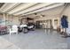 Spacious garage with epoxy flooring, custom storage cabinets, and a golf cart at 305 Kentmere Ln, Clover, SC 29710