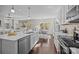 Bright, modern kitchen with stainless steel appliances and a large island at 305 Kentmere Ln, Clover, SC 29710