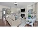 Cozy living room with a fireplace, neutral tones, and plenty of seating at 305 Kentmere Ln, Clover, SC 29710