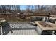 Back deck with comfortable outdoor seating area and wooded backyard at 312 Sailwinds Rd, Mooresville, NC 28115