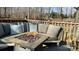 Outdoor seating area with an outdoor fire pit on the back deck overlooking the backyard at 312 Sailwinds Rd, Mooresville, NC 28115