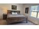 Comfortable bedroom with wood furnishings, a neutral color scheme, and natural light from the window at 312 Sailwinds Rd, Mooresville, NC 28115