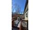 View of the deck with outdoor seating and view of white fencing and trees at 312 Sailwinds Rd, Mooresville, NC 28115