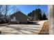 View of the side exterior of home with brick foundation and long driveway at 312 Sailwinds Rd, Mooresville, NC 28115
