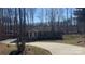 Charming single-story home with a long driveway and a welcoming front porch nestled amongst trees at 312 Sailwinds Rd, Mooresville, NC 28115