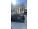 View of the front porch with white railings, landscaping, and large decorative container at 312 Sailwinds Rd, Mooresville, NC 28115