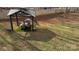Gazebo with table, seating, and grill on artificial turf surrounded by trees at 312 Sailwinds Rd, Mooresville, NC 28115