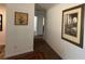 A hallway with neutral walls features a painting and framed Lake Norman print at 312 Sailwinds Rd, Mooresville, NC 28115